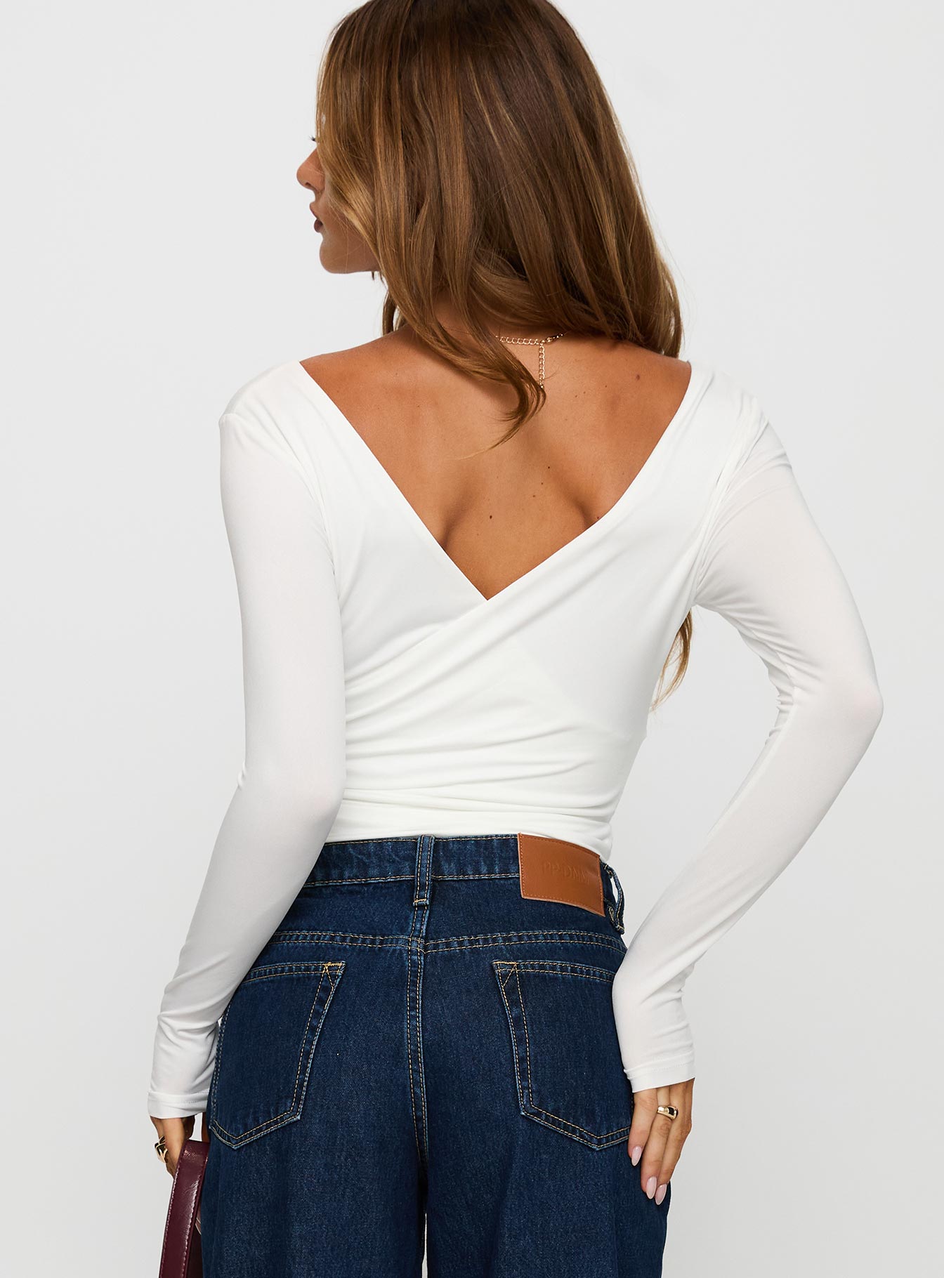 back view of model wearing Princess Polly Right Here Cross Detail Bodysuit White Long Sleeve Tops 