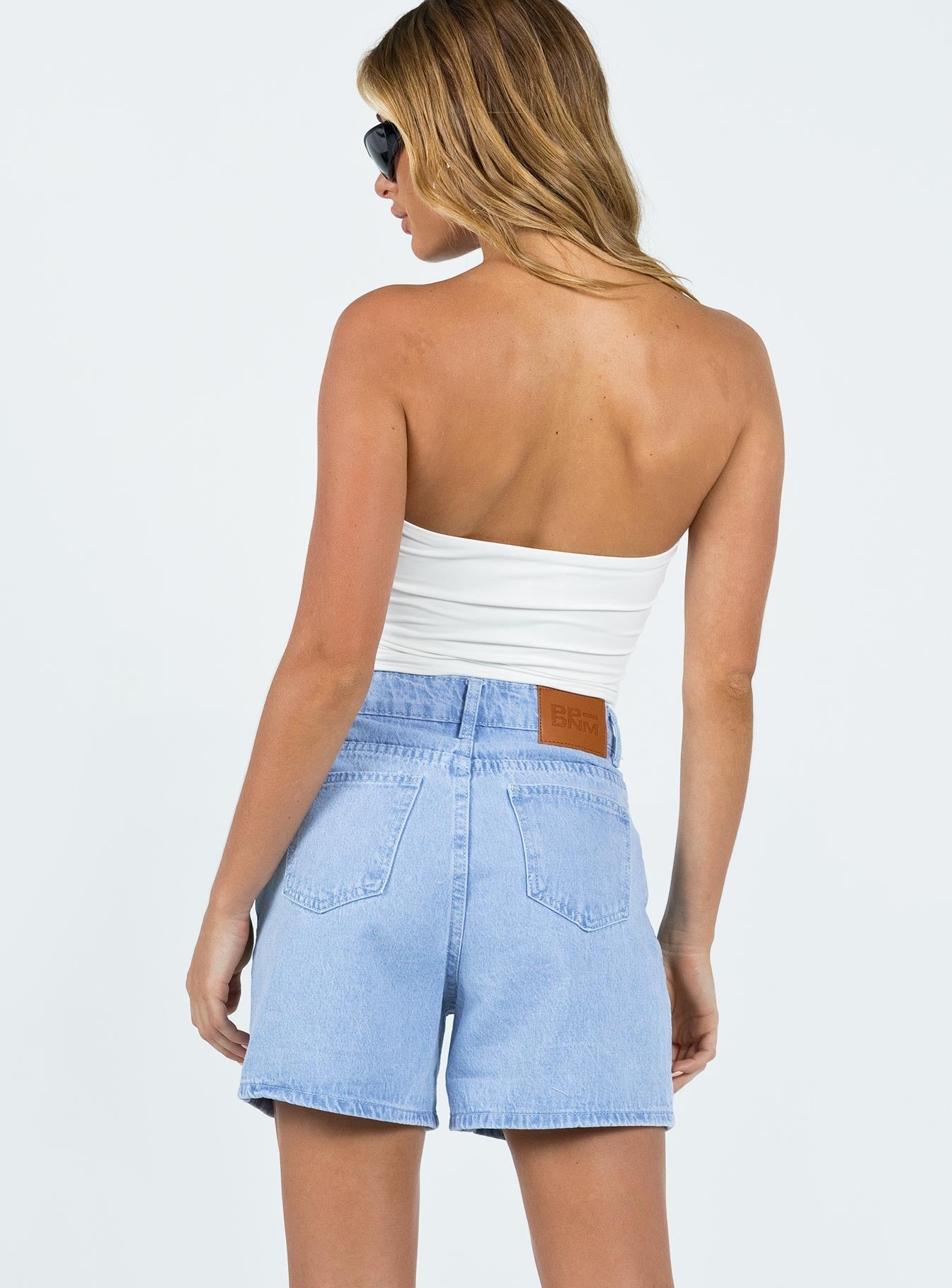 back view of model wearing Princess Polly The Swalla Shorts Light Blue Lower Impact High Waisted Shorts 
