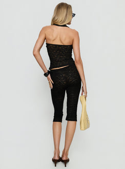 back view of model wearing Princess Polly Babydoll Capri Pants Noir Mid Rise Pants 