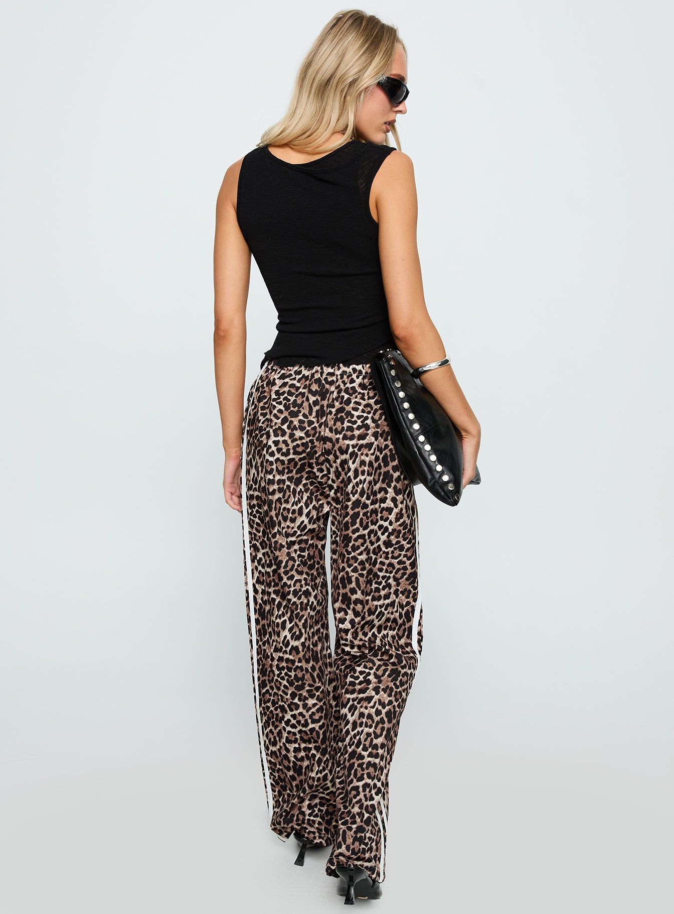 back view of model wearing Princess Polly Buzzer Track Pants Leopard High Waisted Pants 