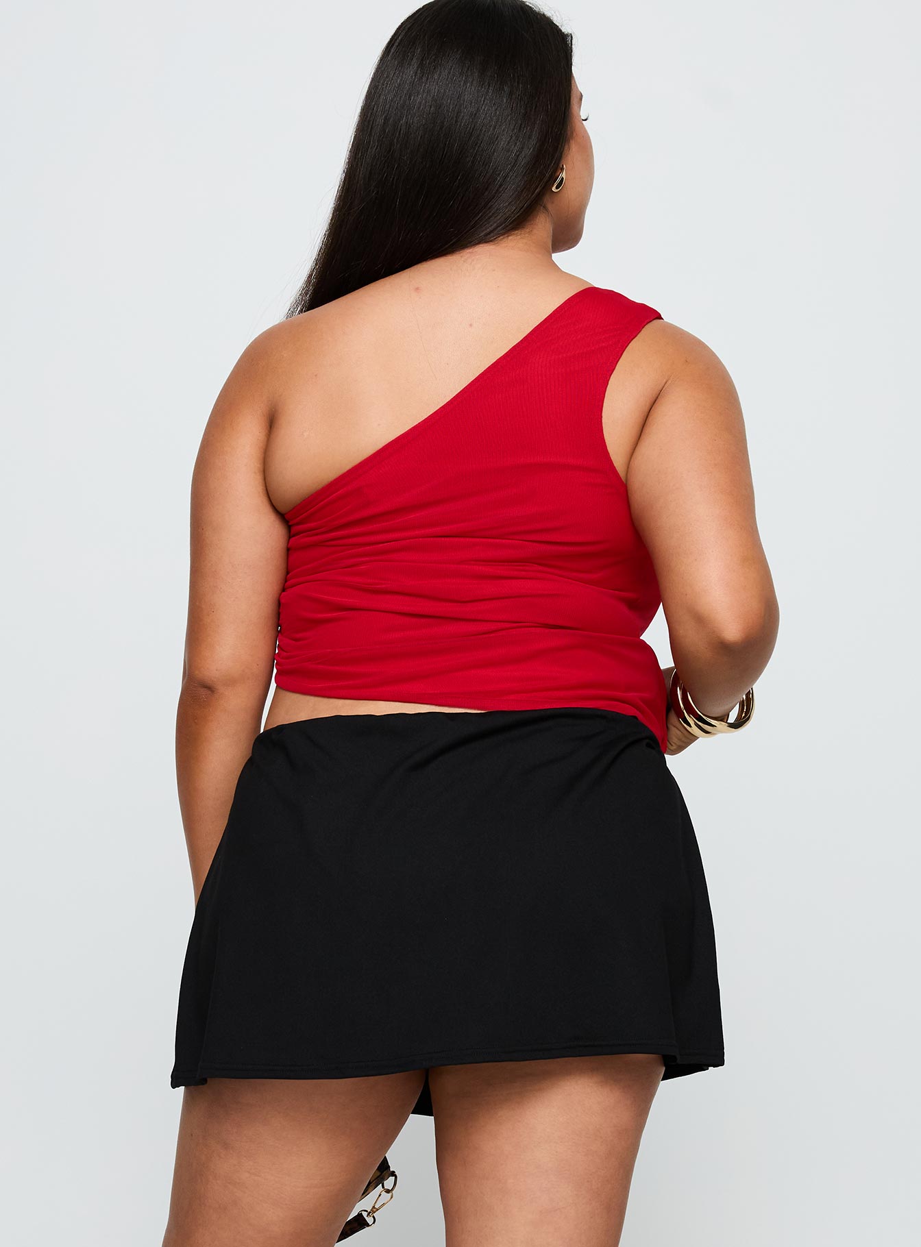 back view of model wearing Princess Polly For The Thrill Skort Black Curve High Waisted Shorts 