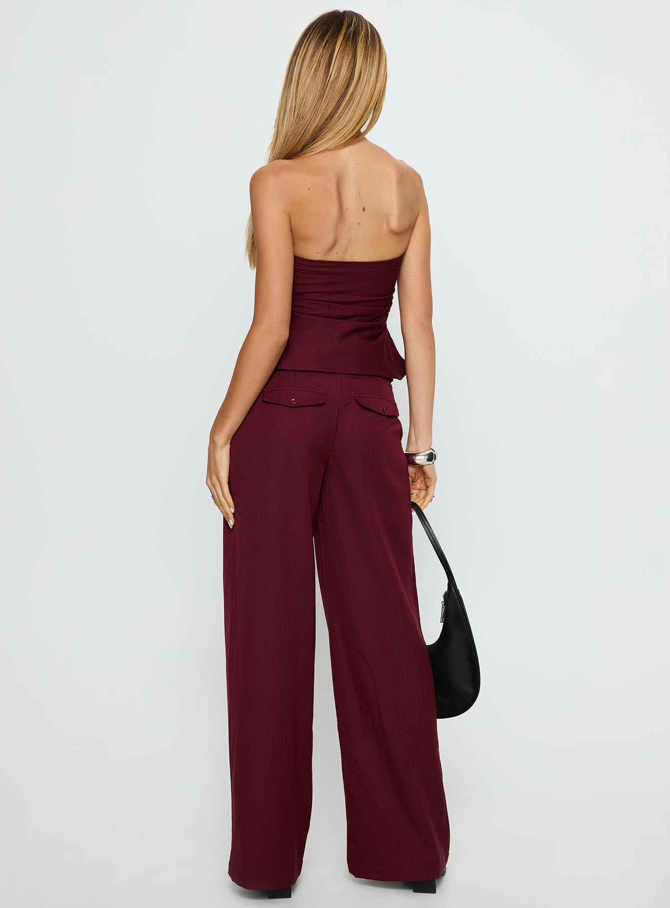 back view of model wearing Princess Polly Jinny Relaxed Buckle Tailored Pants Berry Pinstripe Low Rise Pants 