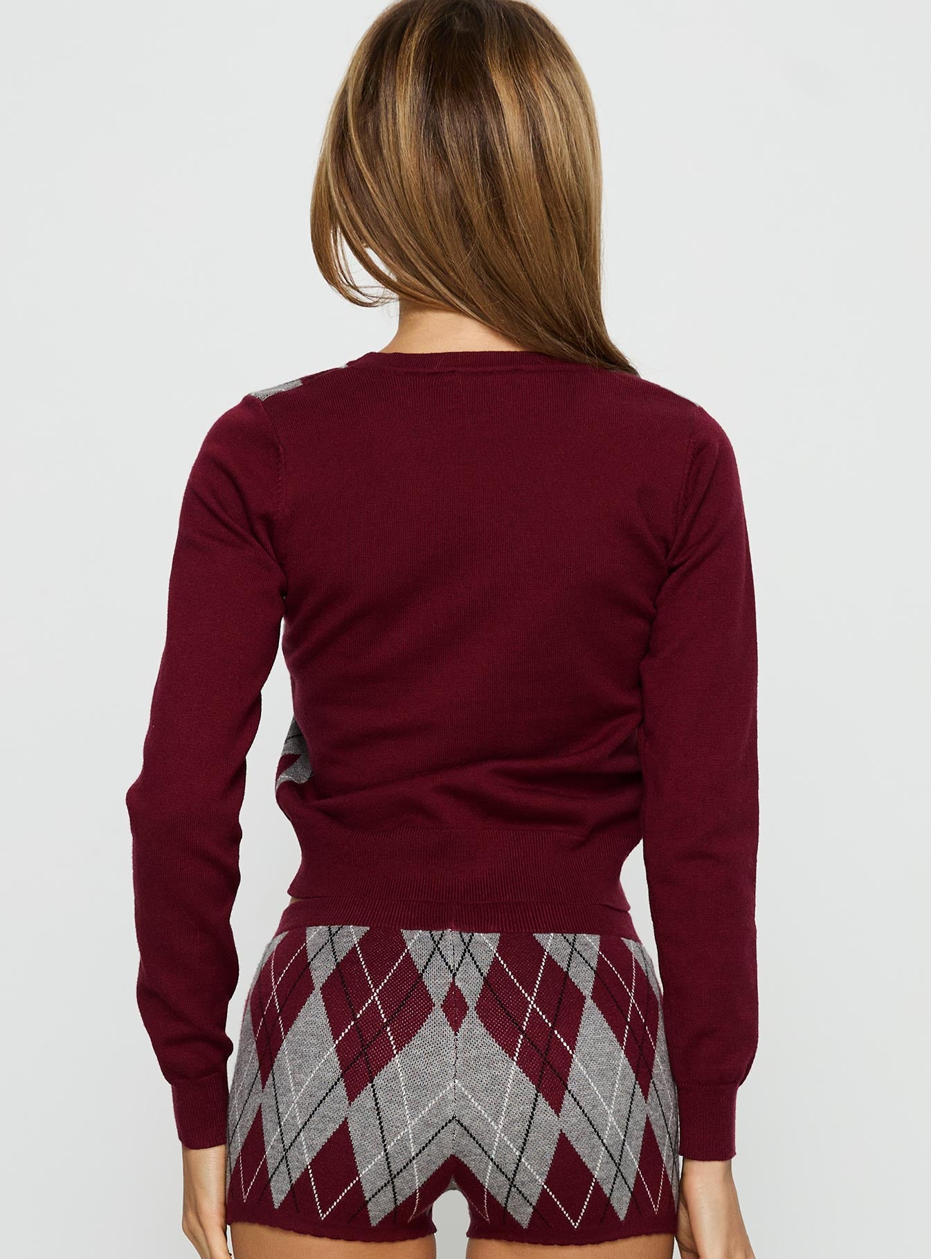 back view of model wearing Princess Polly Raiven Knit Cardigan Burgundy Argyle cropped 