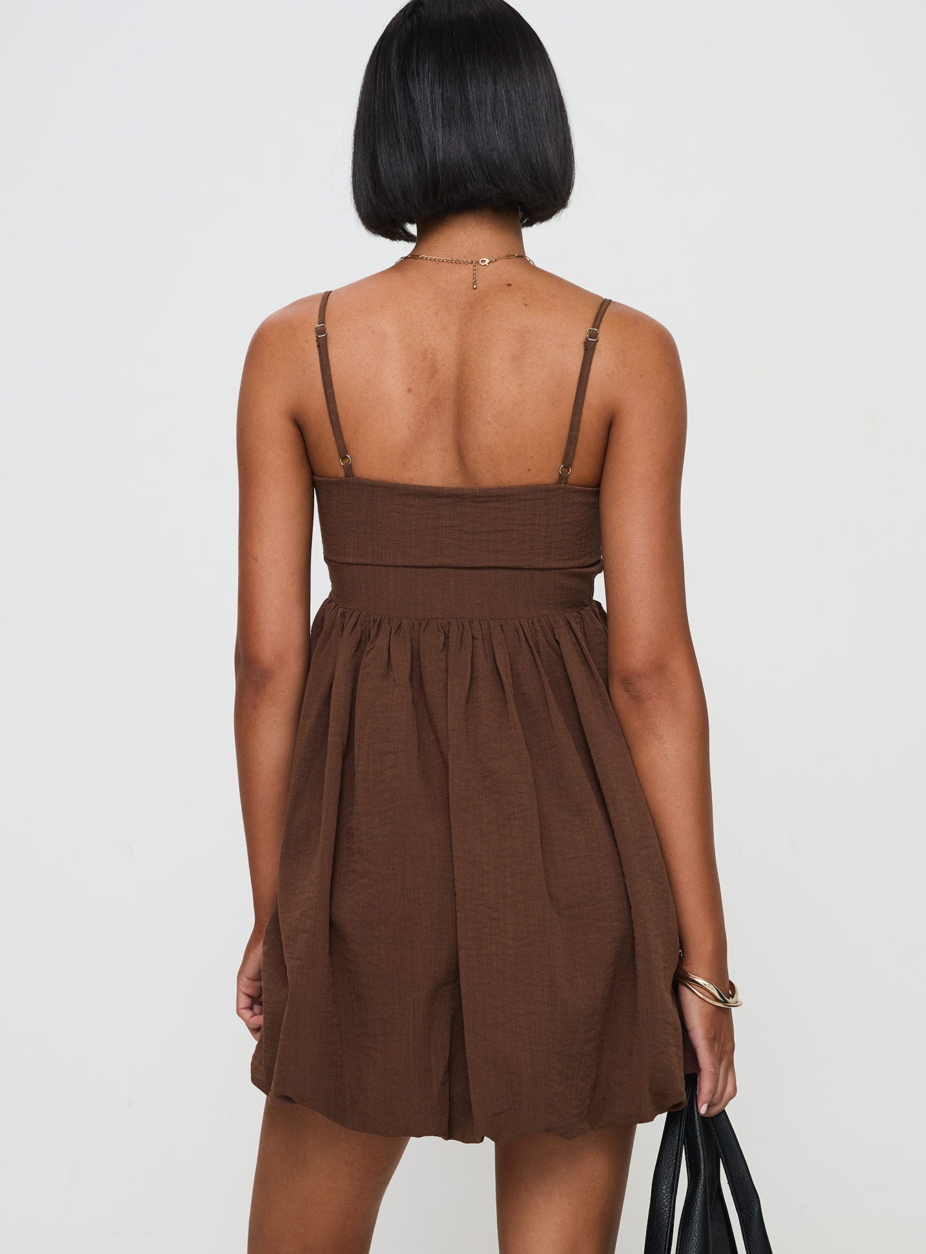 back view of model wearing Princess Polly Layken Bubble Hem Mini Dress Chocolate Petite Square Neck 