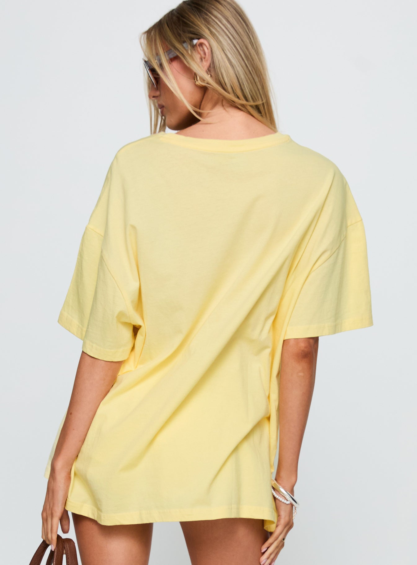 back view of model wearing Princess Polly Amalfi Coast Oversized Graphic Tee Pastel Yellow Half Sleeves Crew Neck 
