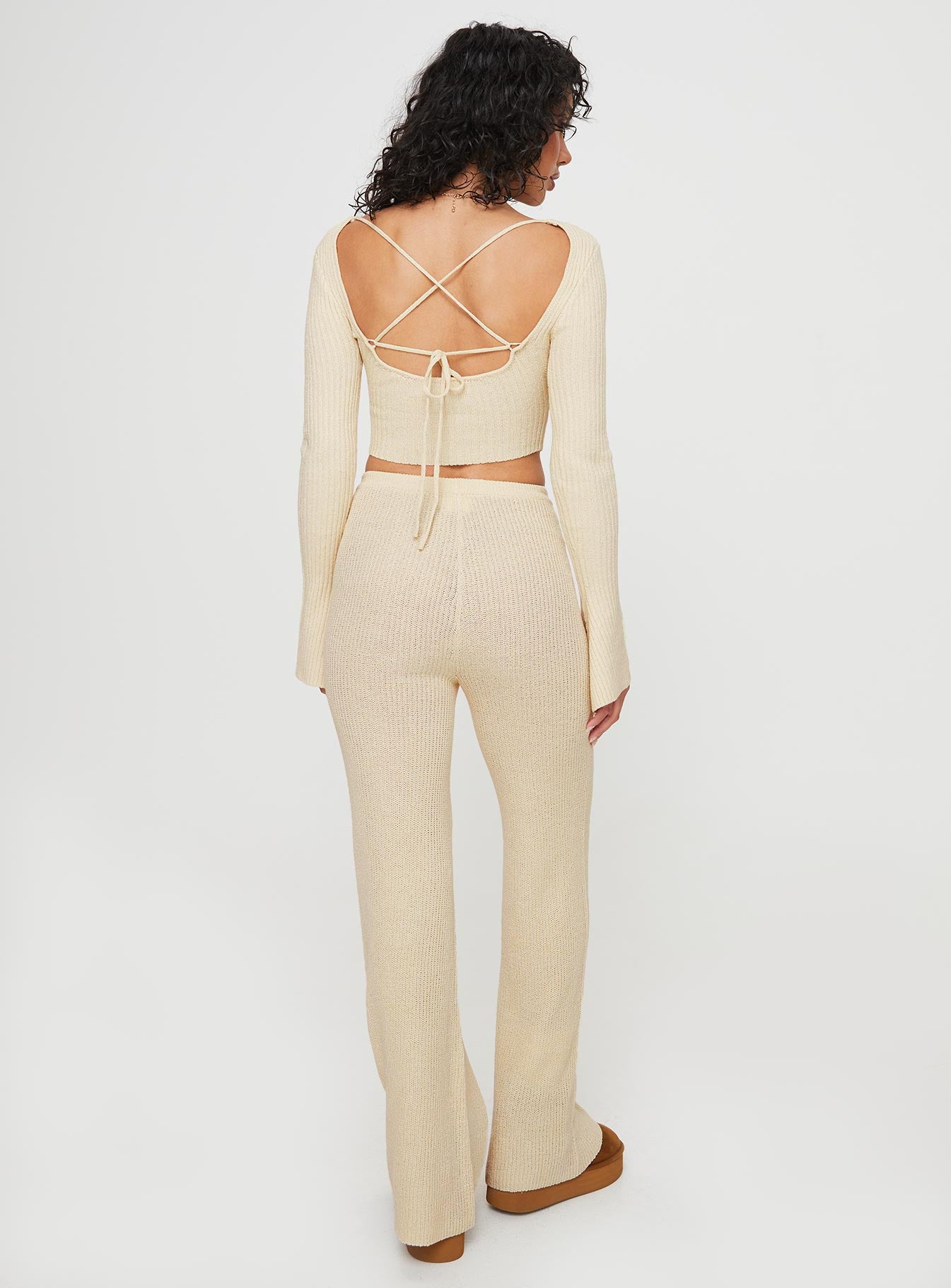 Knit set  Long sleeve crop style top, scoop neckline, flared sleeves, low back with cross fastening ties Mid-rise slightly flared pants, elasticated waistband  Good stretch, unlined