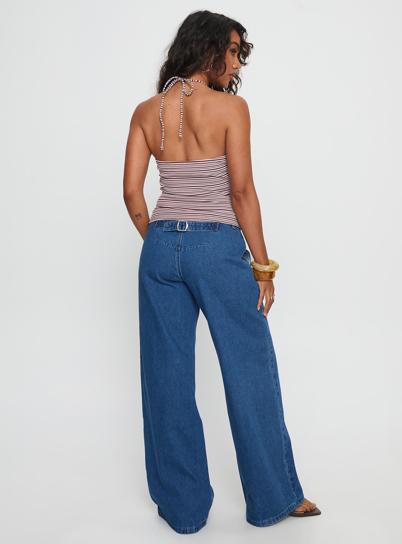 back view of model wearing Princess Polly Polaris Mid Rise Straight Leg Jeans Mid Blue Mid Rise Jeans 
