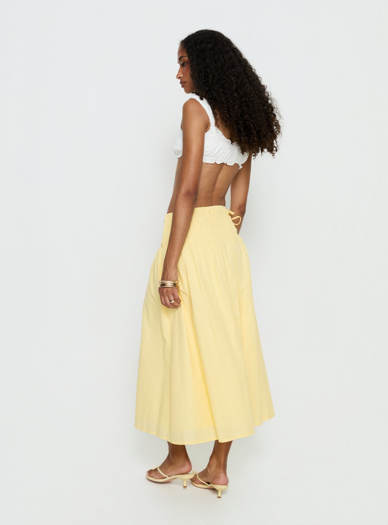 back view of model wearing Princess Polly Vence Ruched Maxi Skirt Lemon Yellow Maxi Skirts 