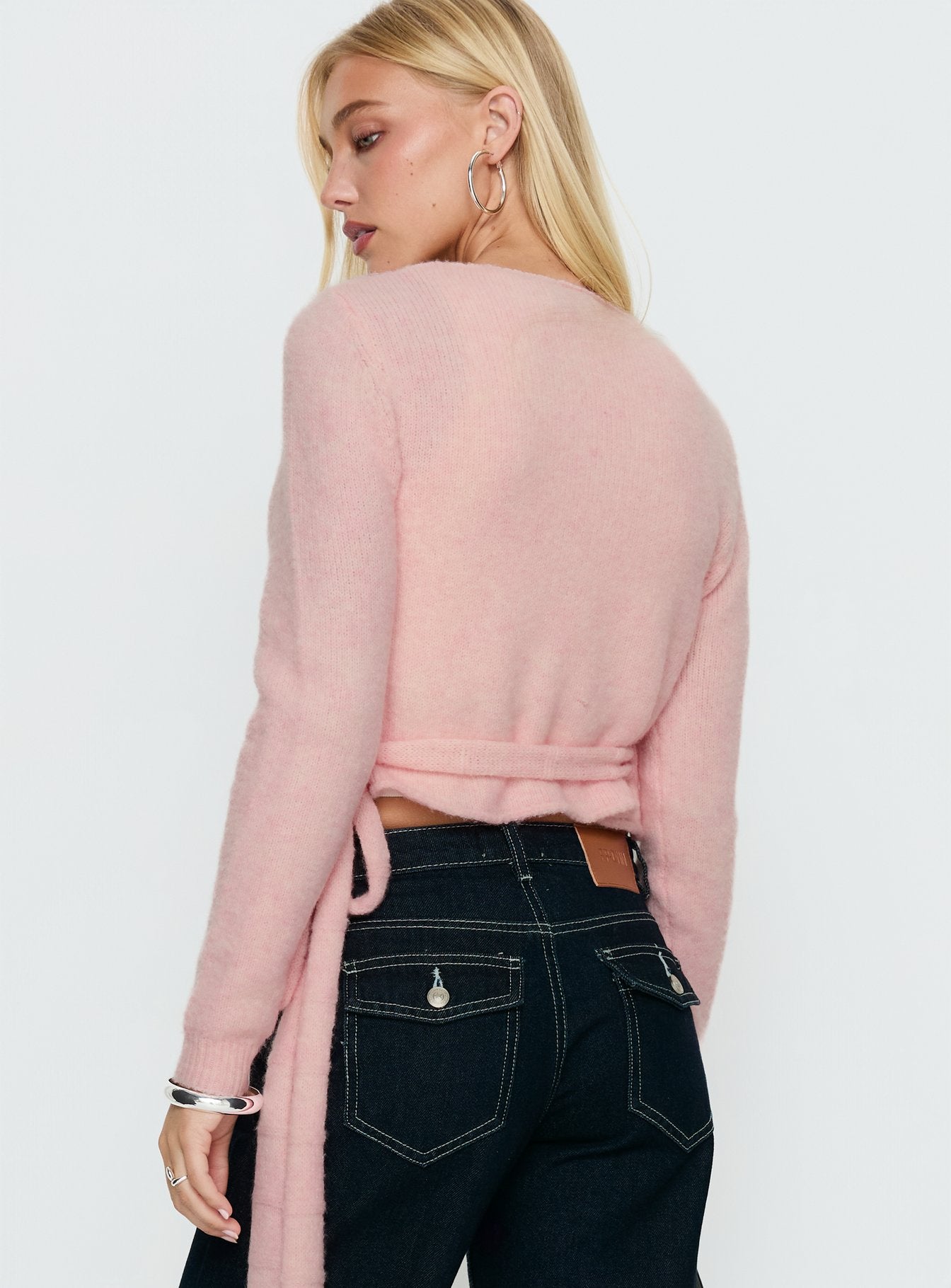 back view of model wearing Princess Polly Tonee Wrap Knit Cardigan Pink cropped 