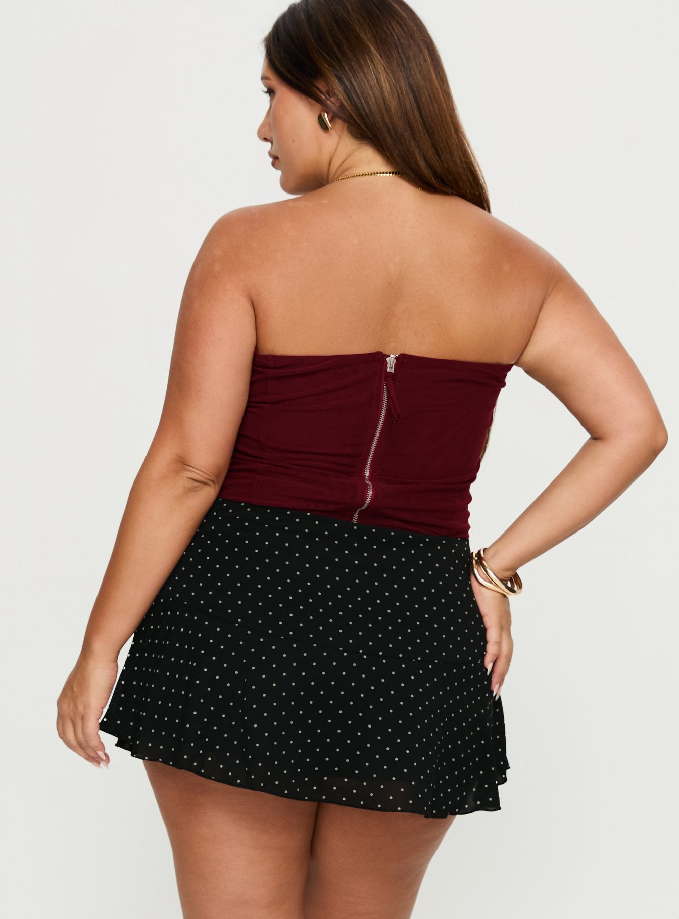 back view of model wearing Princess Polly Sonsie Mini Skirt Black / White Polka Curve 