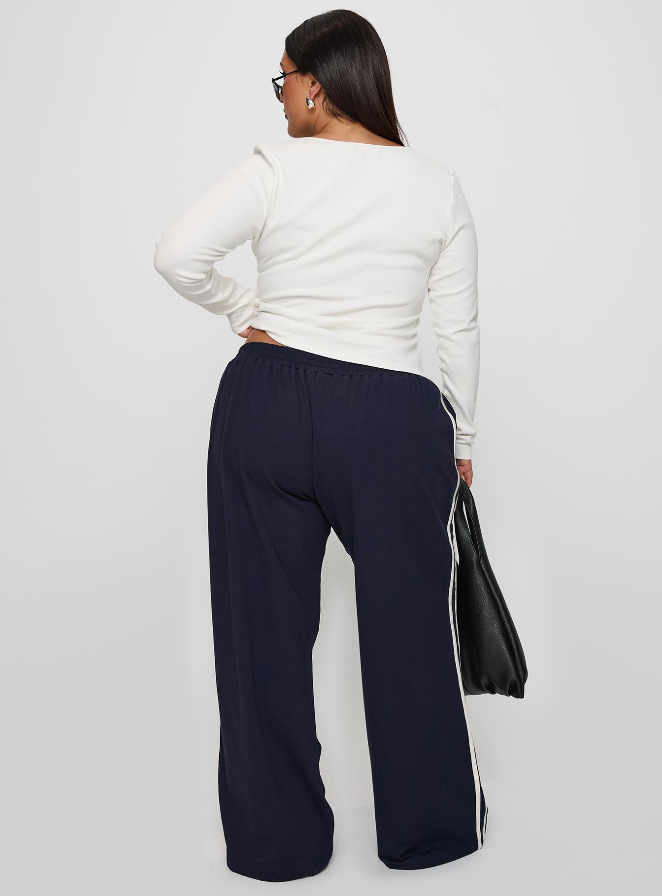 back view of model wearing Princess Polly Circuit Track Pants Navy Curve 