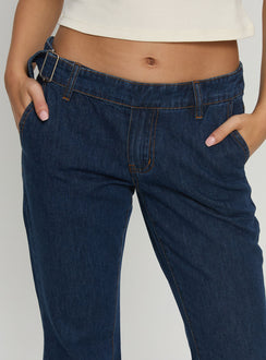back view of model wearing Princess Polly Acapulco Low Rise Flare Jeans Dark Blue Wash Low Rise Jeans 