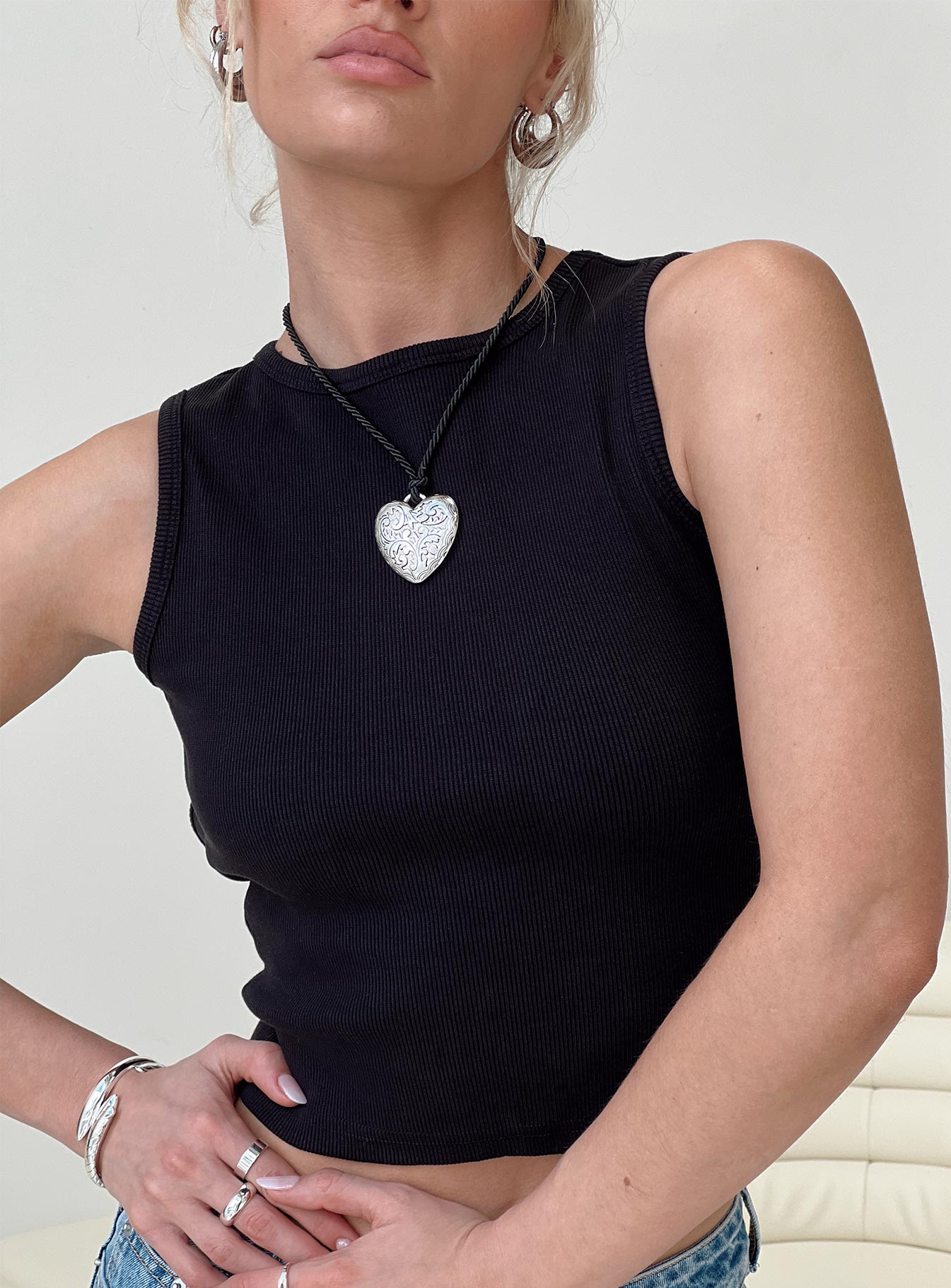 Front view of model wearing  front Princess Polly Sleeveless High Neck  Haina Open Back Tank Top Black