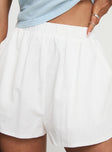 back view of model wearing Princess Polly Fealure Shorts White High Waisted Shorts 