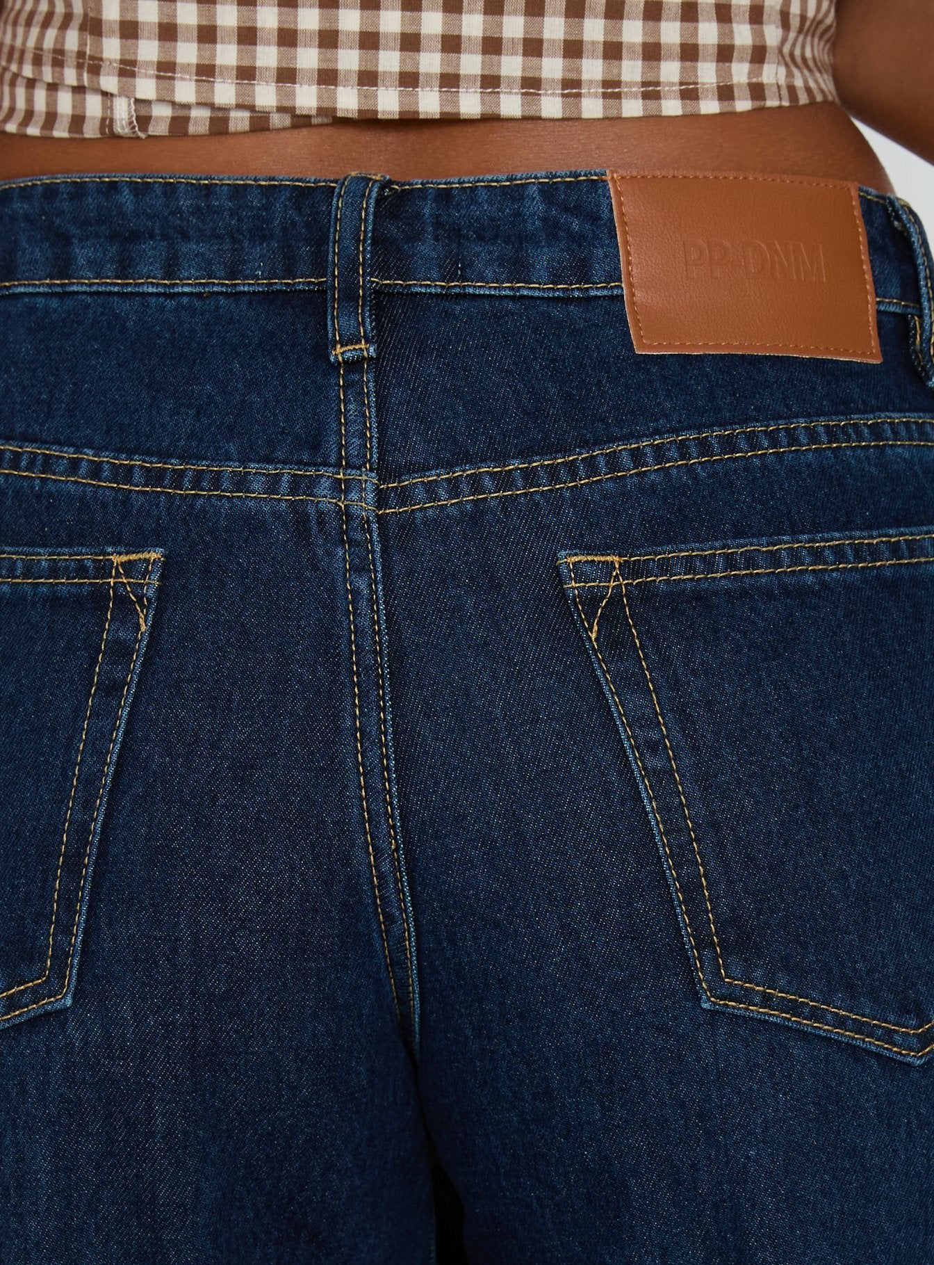 back view of model wearing Princess Polly Darla Low Rise Straight Leg Cuff Jean Dark Blue Wash Low Rise Jeans 