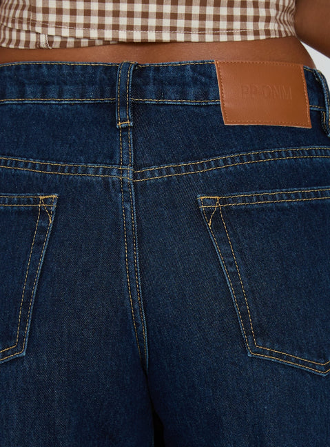 back view of model wearing Princess Polly Darla Low Rise Straight Leg Cuff Jean Dark Blue Wash Low Rise Jeans 