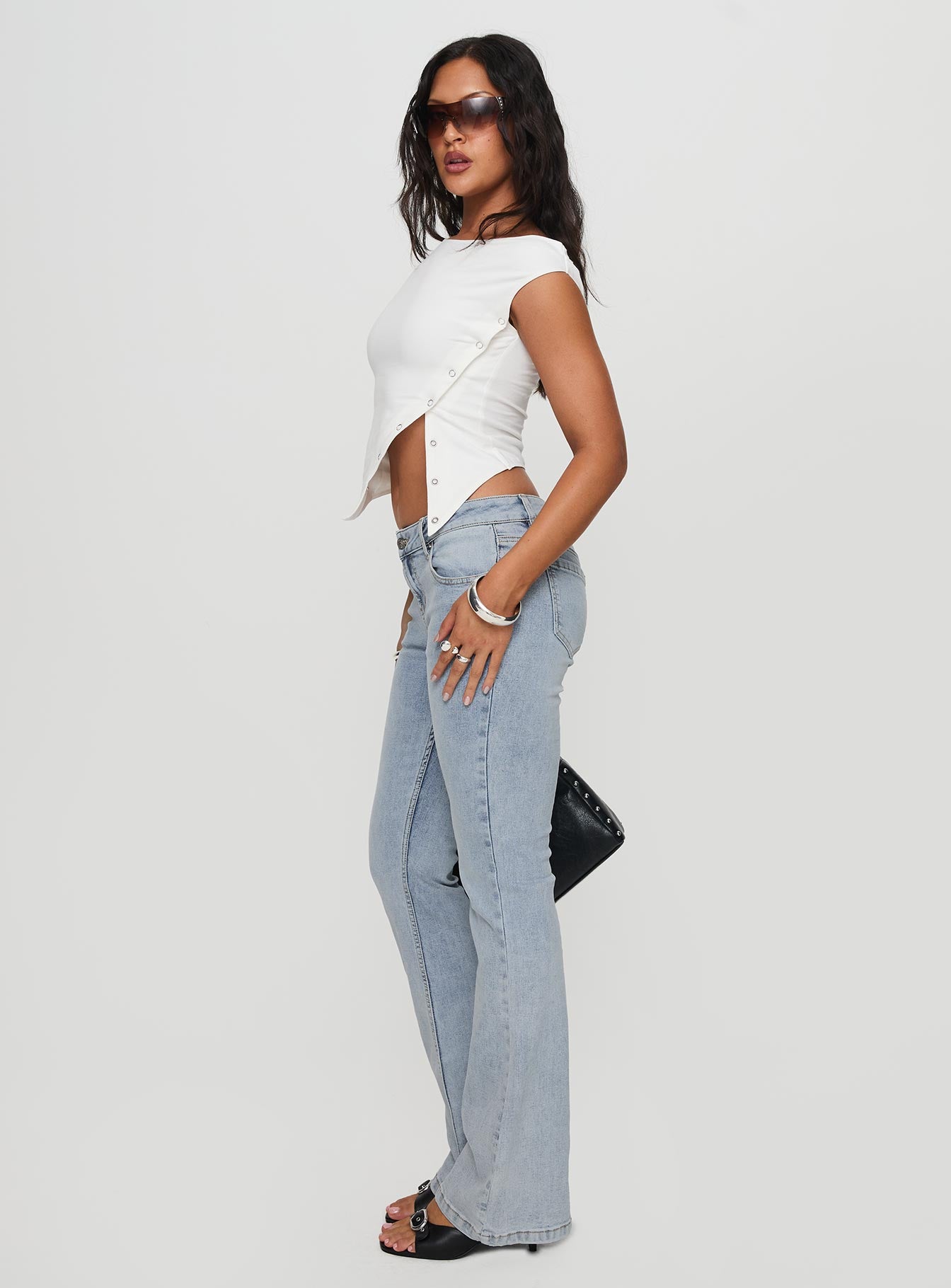 side view of model wearing Princess Polly Bethany Bootleg Low Rise Jeans Light Wash Low Rise Jeans 