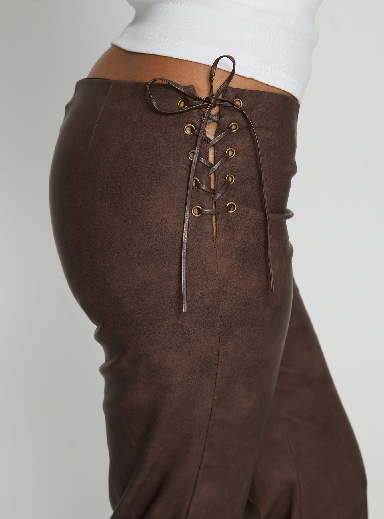 side view of model wearing Princess Polly Trickrider Tie Side Faux Leather Pants Chocolate Mid Rise Pants 