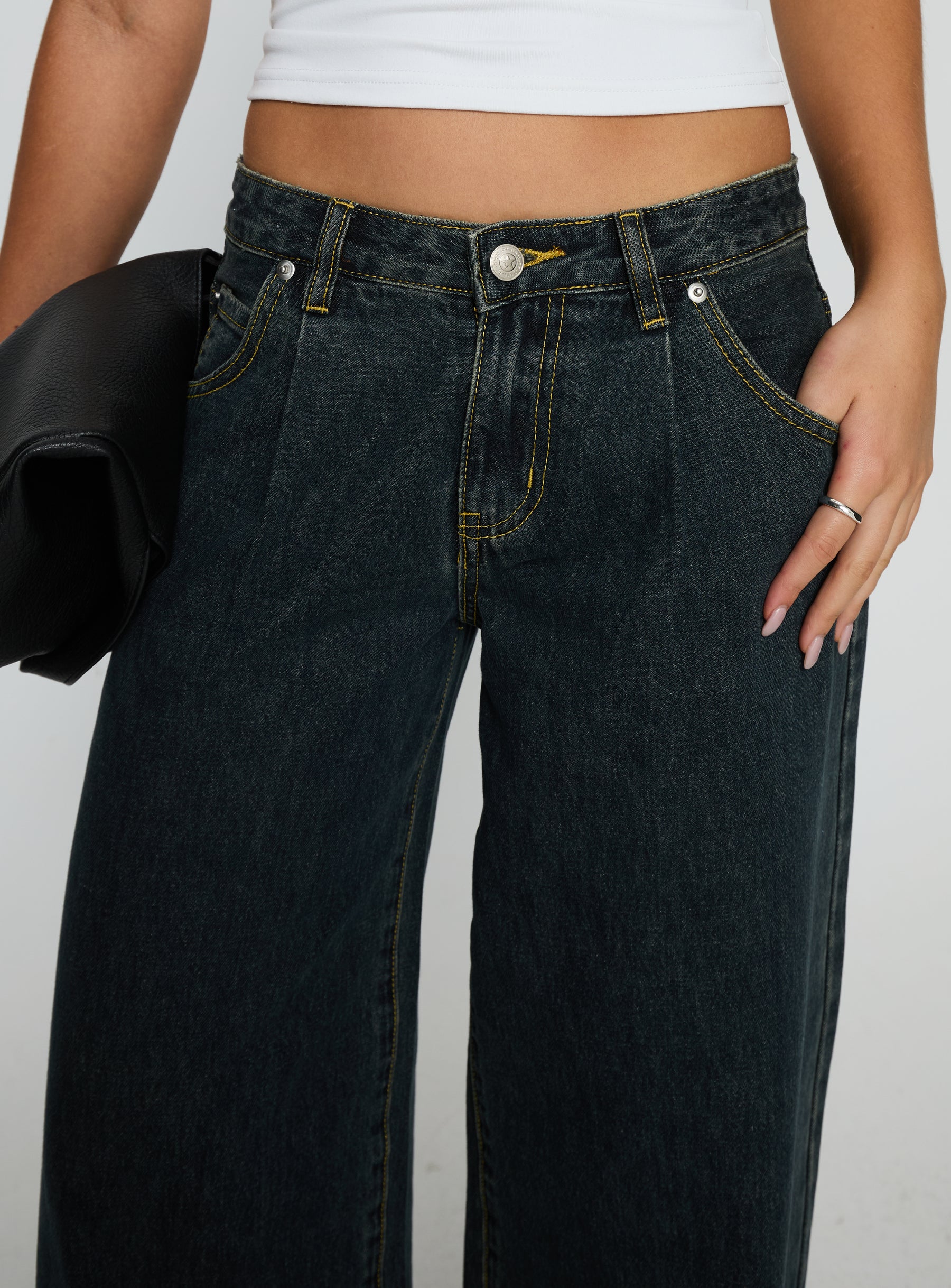 side view of model wearing Princess Polly Supercut Low Rise Baggy Pleat Jeans Grunge Wash Low Rise Jeans 