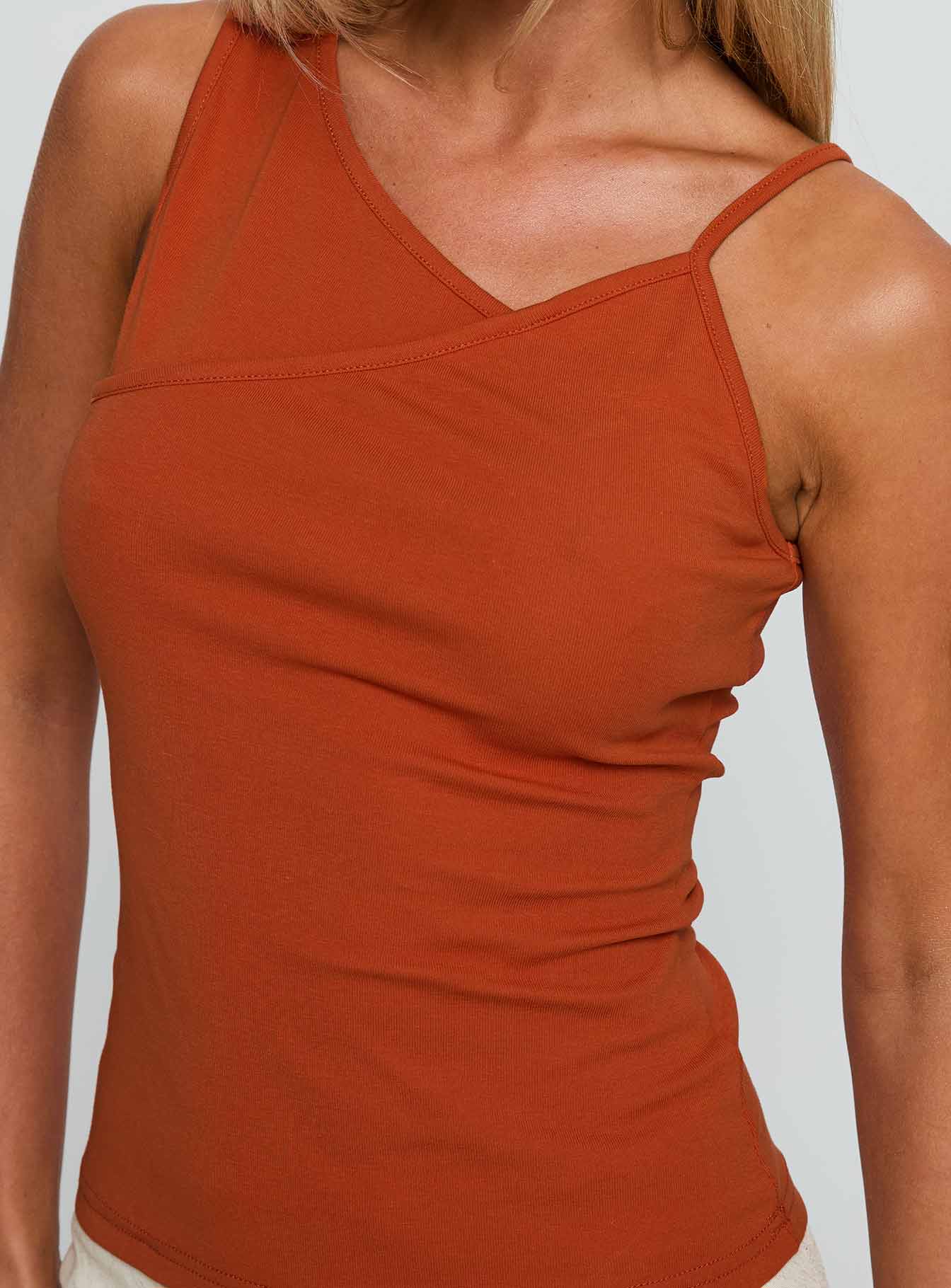 back view of model wearing Princess Polly Amarante Sleeveless Top Orange Sleeveless Asymmetric Neckline 