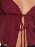 Burgundy Long sleeve top Halterneck style, v neckline, tie closure at front, split hem Good stretch, partially lined