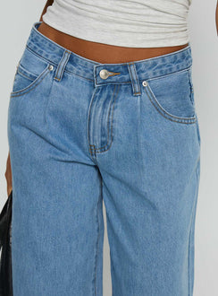 side view of model wearing Princess Polly Supercut Low Rise Baggy Pleat Jeans Light Blue Wash Low Rise Jeans 