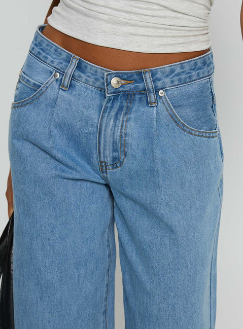 side view of model wearing Princess Polly Supercut Low Rise Baggy Pleat Jeans Light Blue Wash Low Rise Jeans 