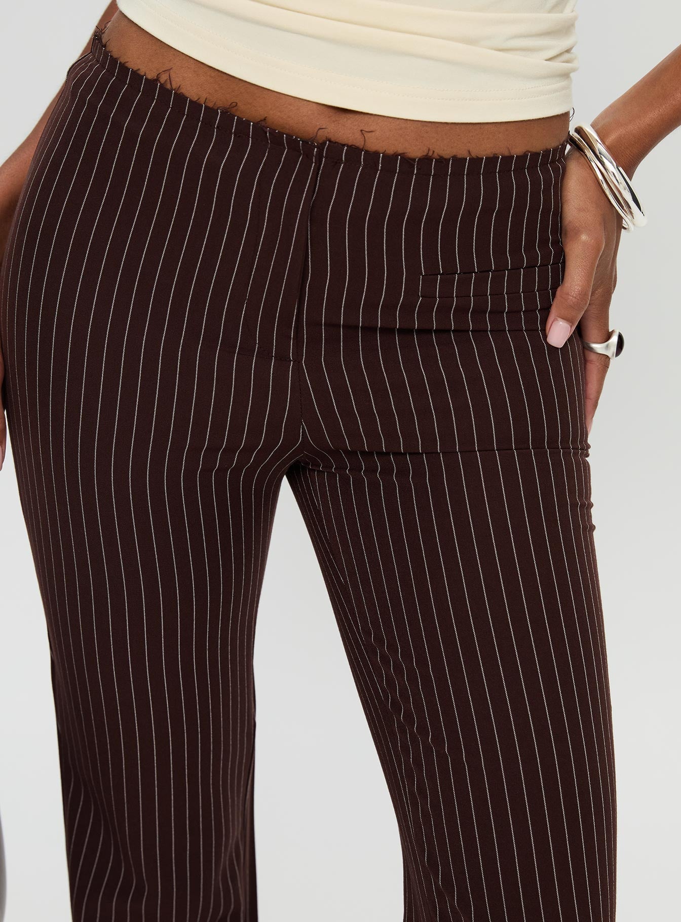 side view of model wearing Princess Polly Sportia Flare Pants Brown High Waisted Pants 