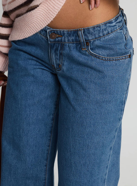 back view of model wearing Princess Polly Highlands Low Rise Wide Leg Jeans Mid Blue Wash Low Rise Jeans 