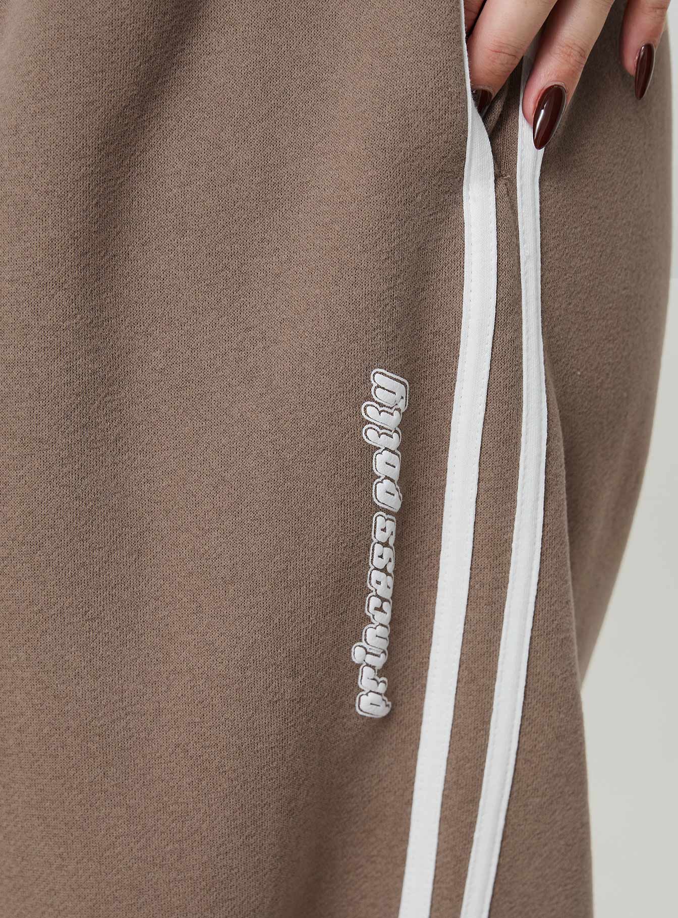 back view of model wearing Princess Polly Princess Polly Track Pants Stripe Taupe / White Curve 