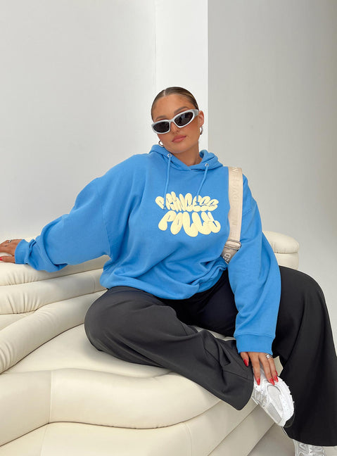 side view of model wearing Princess Polly Princess Polly Hoodie Sweatshirt Bubble Text Blue / Yellow Curve regular 