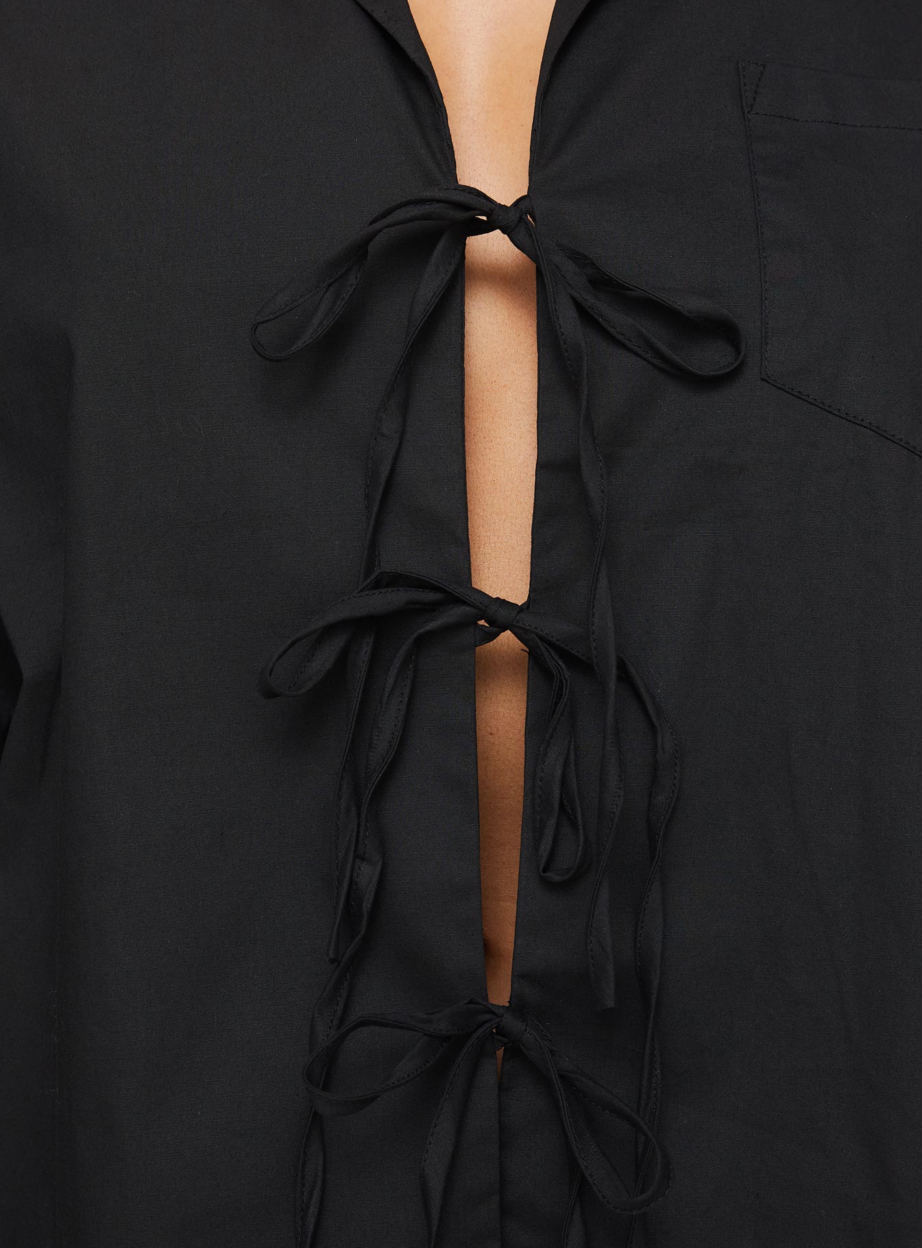 back view of model wearing Princess Polly Spiri Shirt Black Full Sleeves V-Neck 