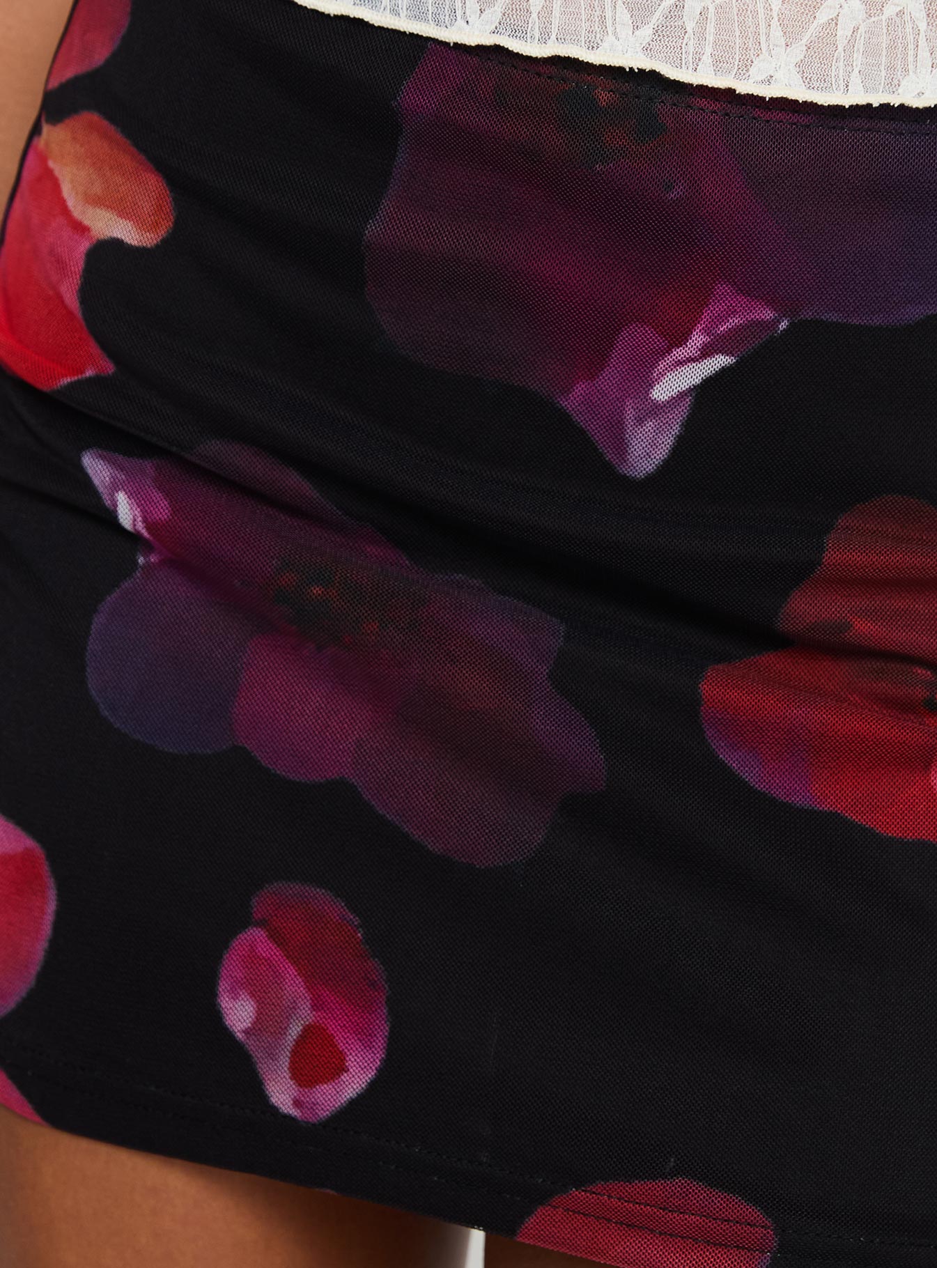 back view of model wearing Princess Polly Kennith Mini Skirt Black / Red Floral 