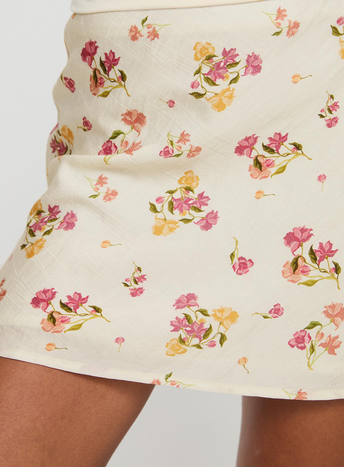   side view of model wearing Princess Polly Sonnet Mini Skirt Cream / Multi Floral Mini Skirts 
