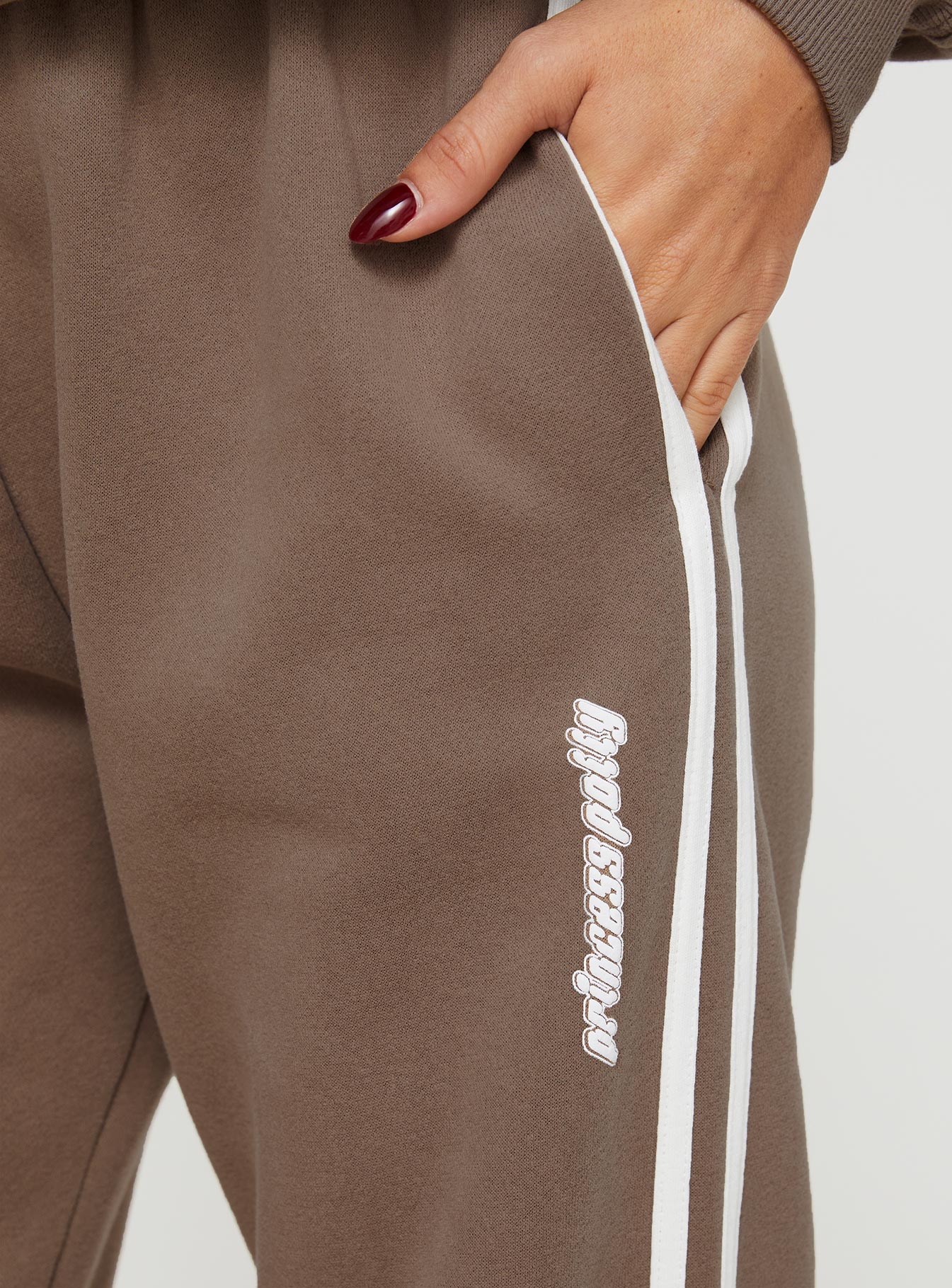 back view of model wearing Princess Polly Princess Polly Track Pants Stripe Taupe / White High Waisted Pants 