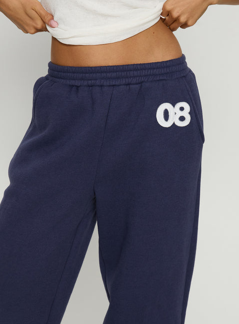 back view of model wearing Princess Polly Route 08 Barrel Track Pant Navy Mid Rise Pants 