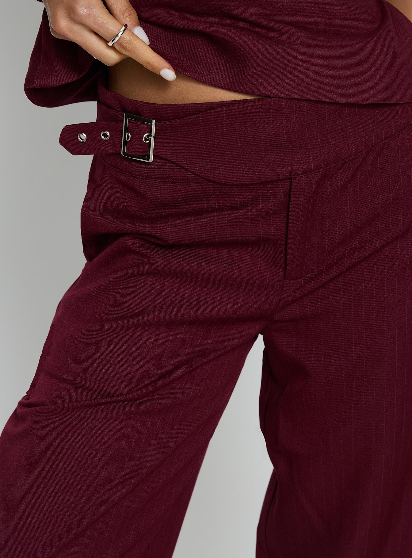 back view of model wearing Princess Polly Jinny Relaxed Buckle Tailored Pants Berry Pinstripe Low Rise Pants 
