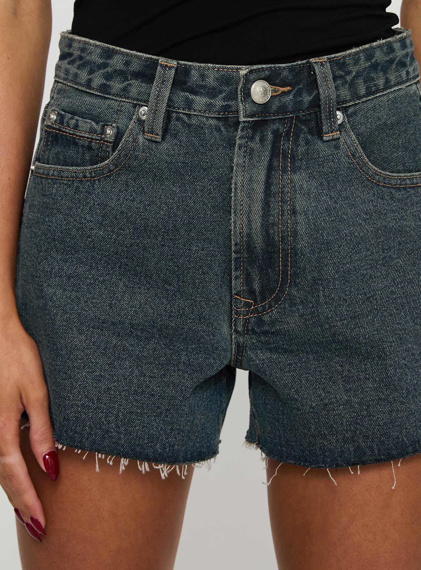 back view of model wearing Princess Polly Get It Right Mid Rise Denim Shorts Dark Denim Wash High Waisted Shorts 