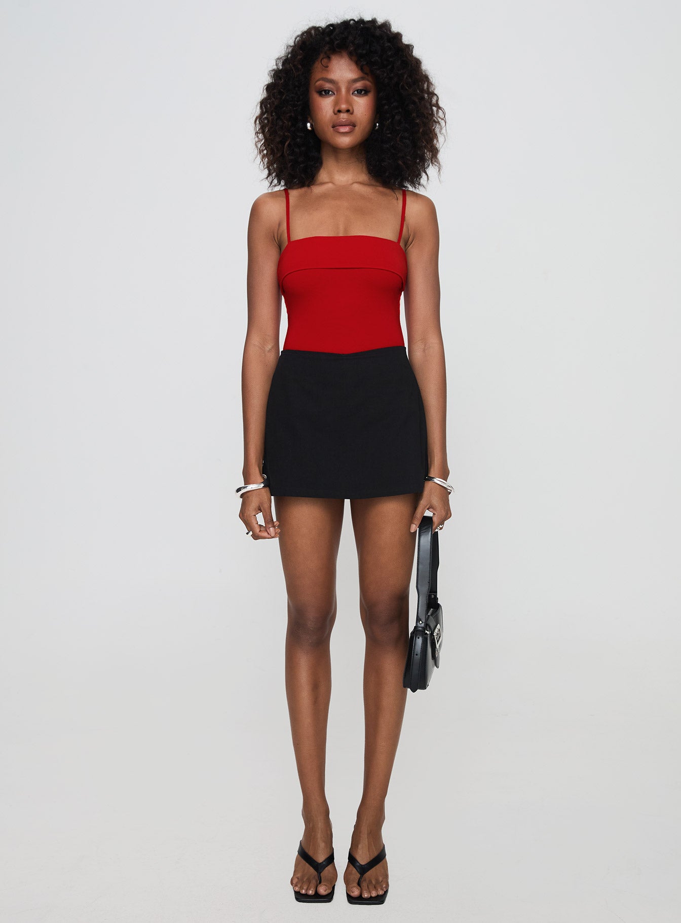 side view of model wearing Princess Polly Lilani Bodysuit Red Sleeveless Square Neck 