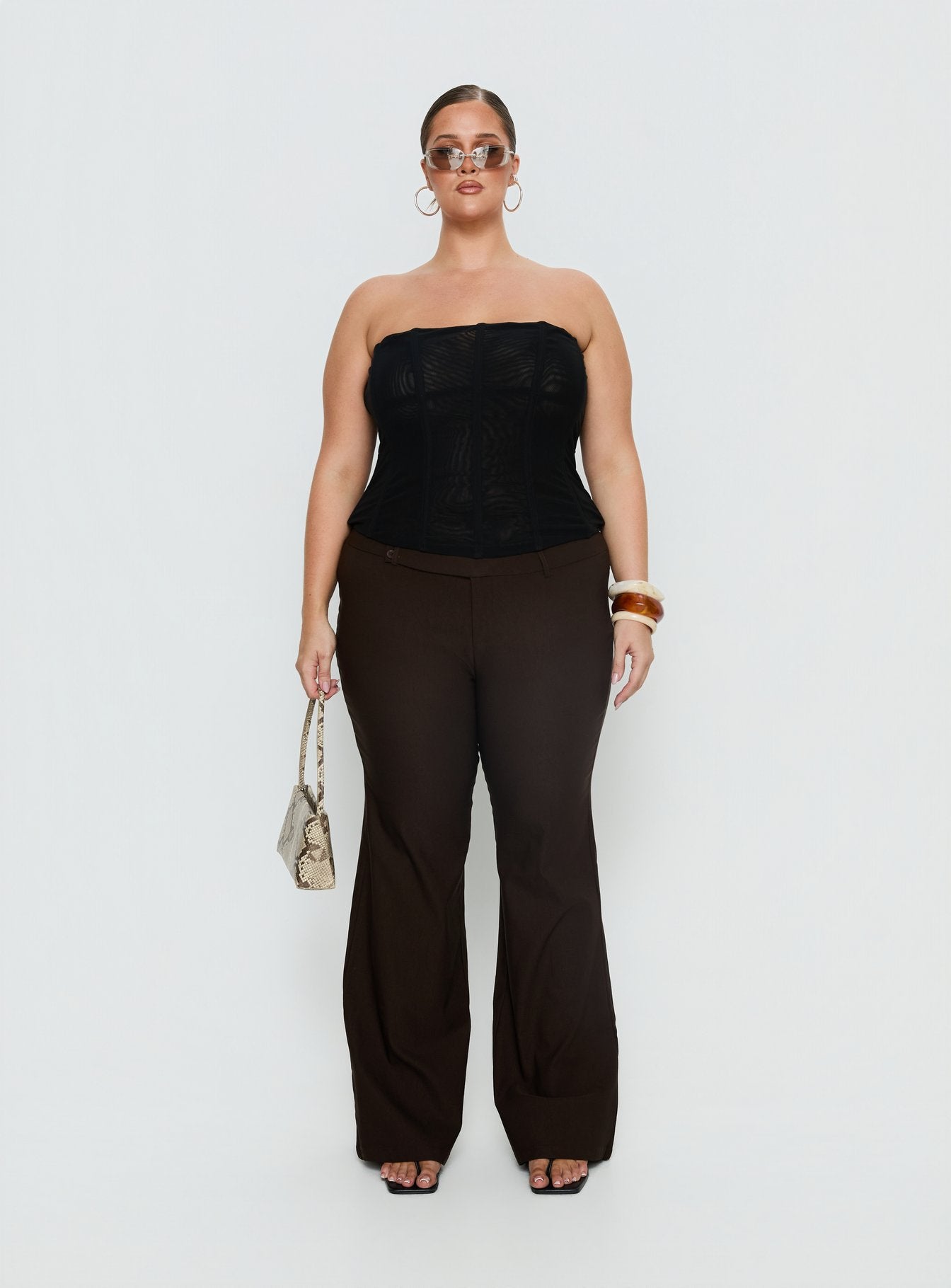 back view of model wearing Princess Polly Kinkirk Flared Pants Chocolate Curve Mid Rise Pants 