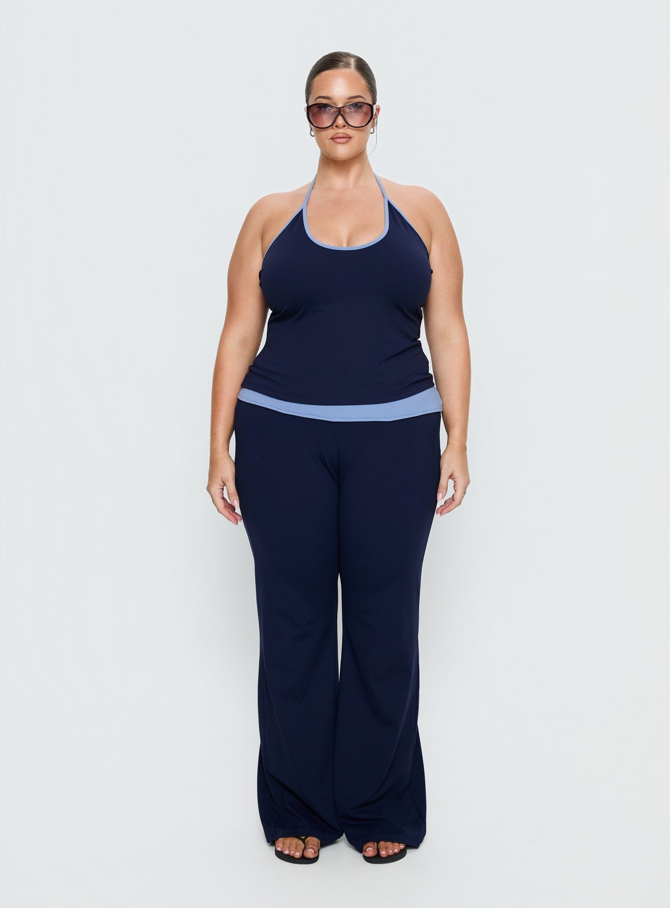 front view of model wearing Princess Polly Kobee Jersey Flare Pants Navy / Light Blue Curve High Rise Pants 