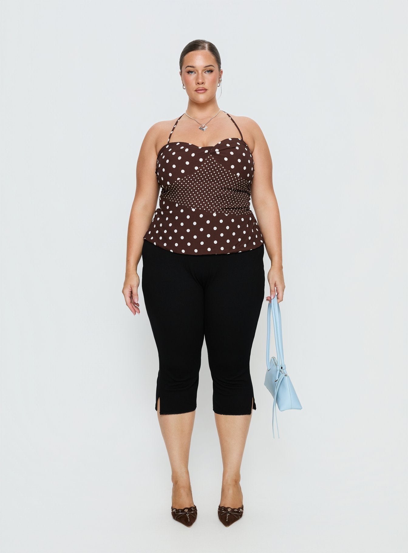 front view of model wearing Princess Polly Baseline Rib Capri Pants Black Curve Mid Rise Pants 