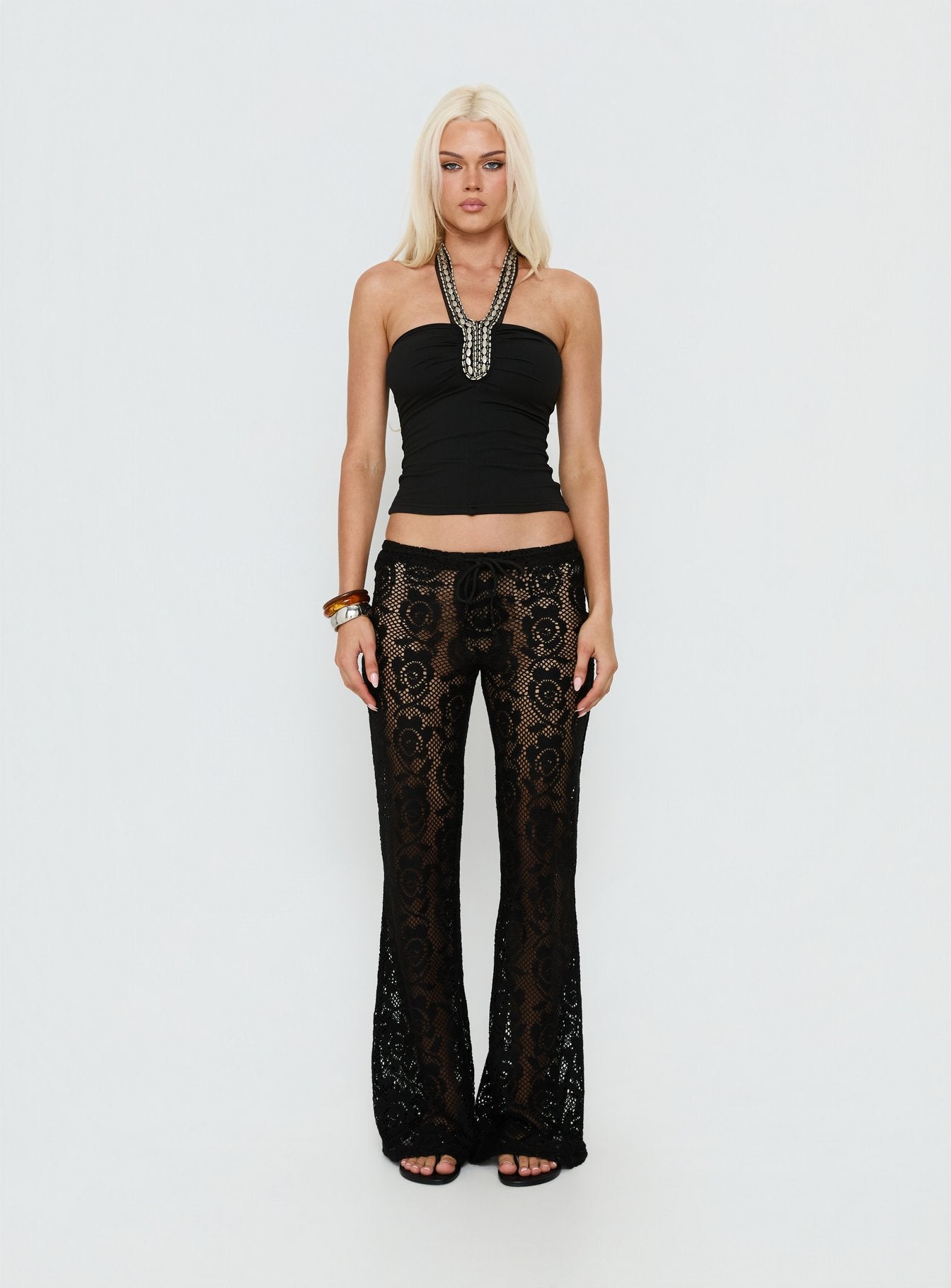 side view of model wearing Princess Polly Rosadonna Lace Flare Pants Black Low Rise Pants 