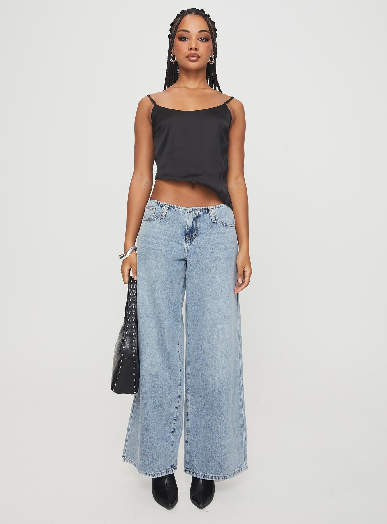 side view of model wearing Princess Polly Olivette Top Black Sleeveless Scoop Neck 