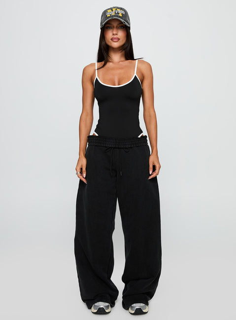 side view of model wearing Princess Polly That Effect Bodysuit Black Sleeveless 