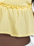 Yellow crop top Muslin look material Adjustable shoulder straps Plunging neckline Ruffle detail