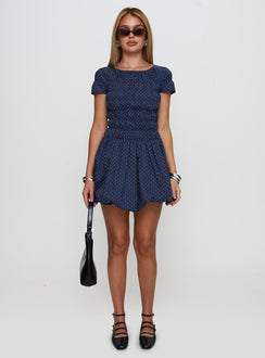 side view of model wearing Princess Polly Kennedia Shirred Bubble Hem Mini Dress Navy Boat Neck 