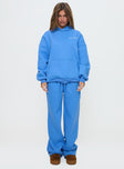 front view of model wearing Princess Polly Princess Polly Hooded Sweatshirt Bubble Text Blue / White Long 