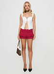 front view of model wearing Princess Polly Deei Double Ruffle Mini Skort Poppy Red Low Rise Shorts 