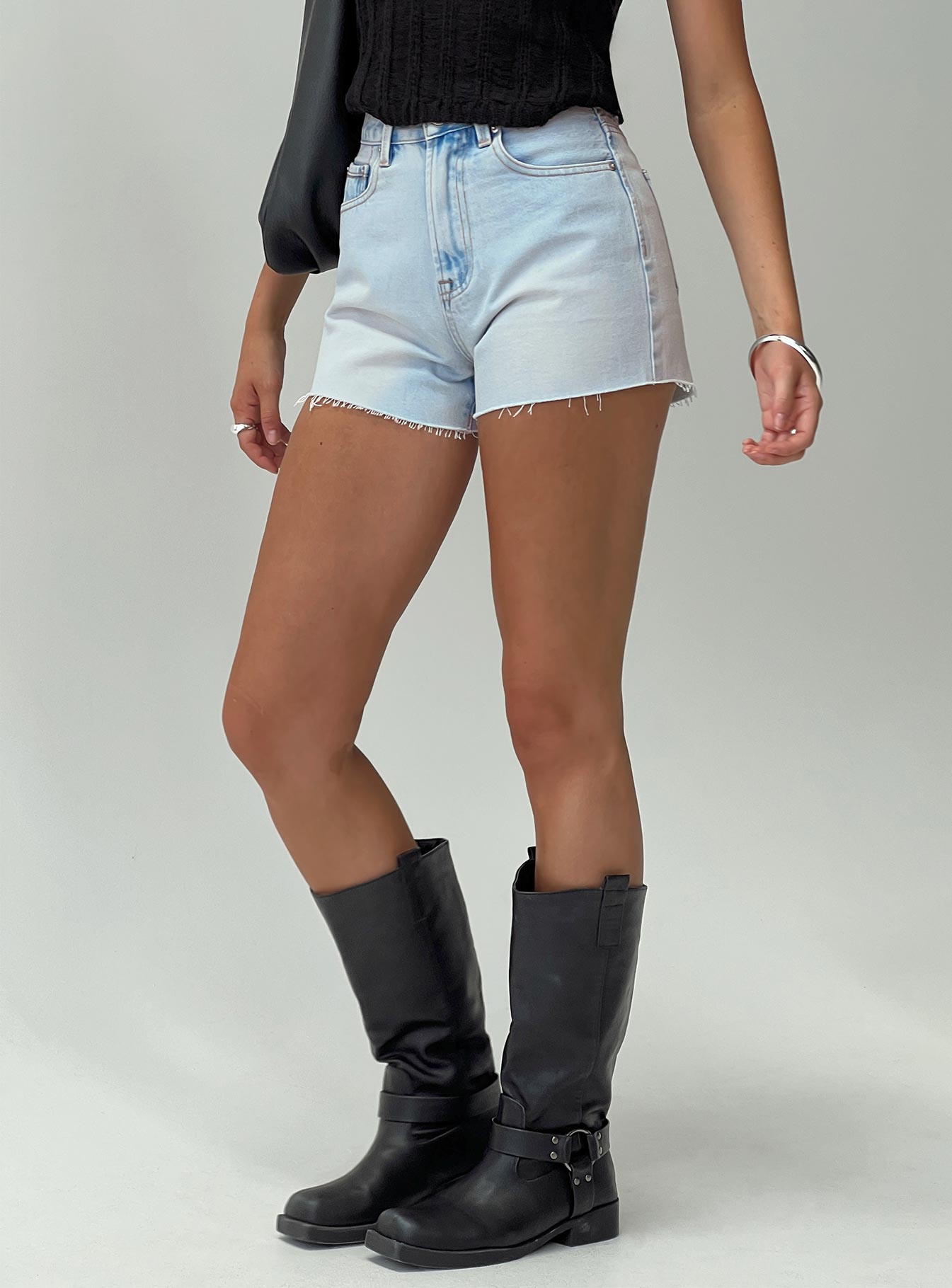 side view of model wearing Princess Polly Get It Right Mid Rise Denim Shorts Light Wash High Waisted Shorts 